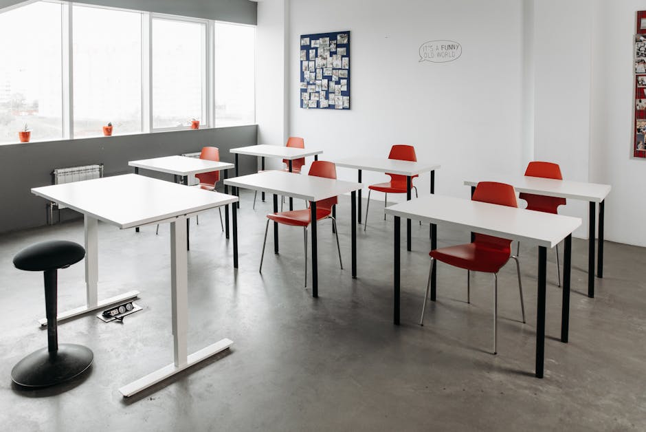 Bright classroom interior with red chairs and minimalist design, perfect for education themes.
